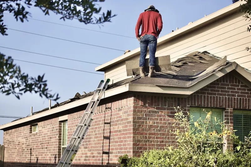 Professional roofer working on a residential roof in Villa Parke
